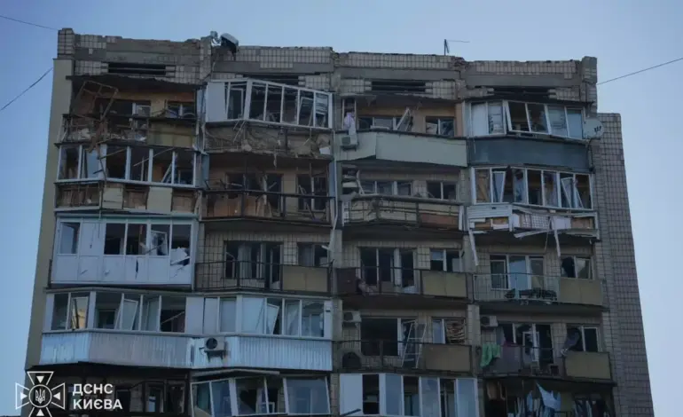 Emergency responders work near a damaged residential building in Kyiv after a Russian overnight attack.